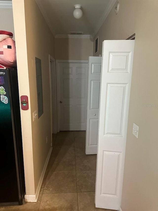 hallway with electric panel, crown molding, and light tile patterned flooring