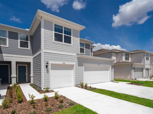 view of property featuring driveway and an attached garage