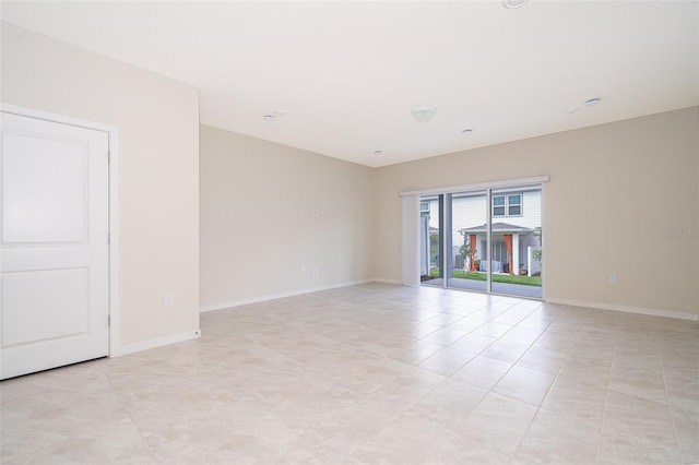 empty room featuring baseboards