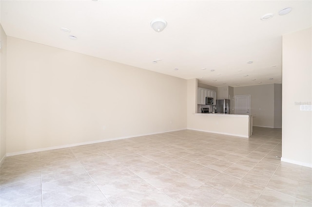 unfurnished room with baseboards