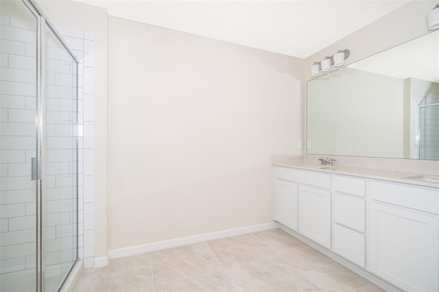 full bathroom featuring a stall shower, a sink, baseboards, and double vanity