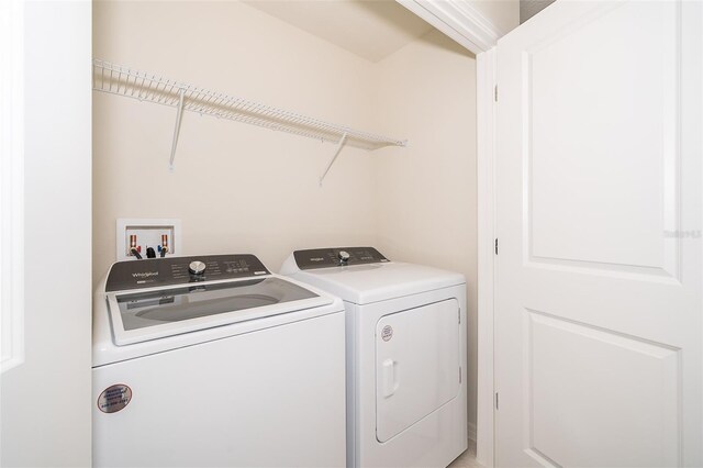 washroom featuring laundry area and washer and clothes dryer