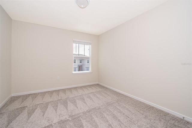 empty room with carpet floors and baseboards