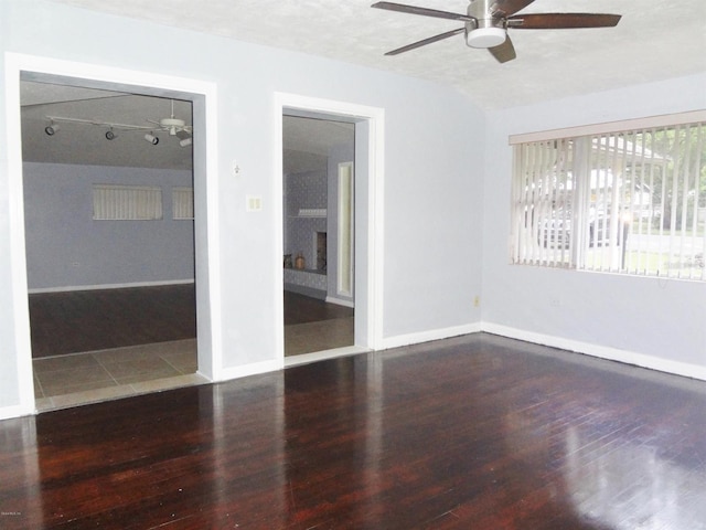 unfurnished room with dark hardwood / wood-style floors and a textured ceiling