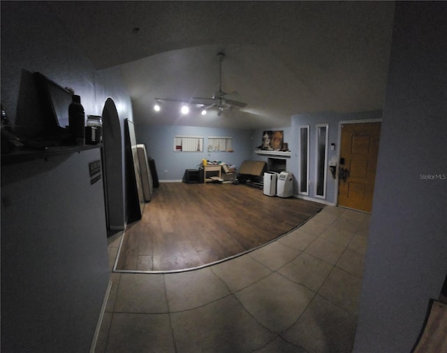 interior space featuring wood-type flooring, vaulted ceiling, and ceiling fan