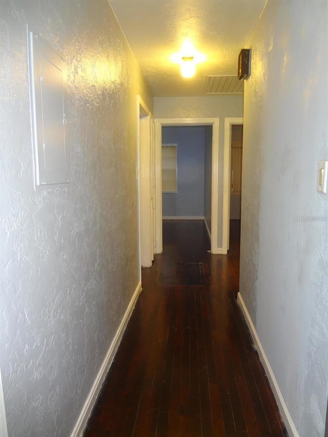 hallway with electric panel and dark hardwood / wood-style floors