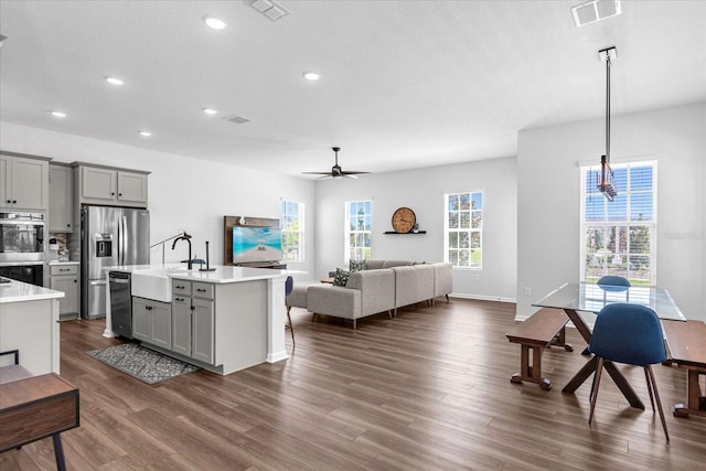 kitchen with stainless steel appliances, ceiling fan, sink, pendant lighting, and gray cabinets