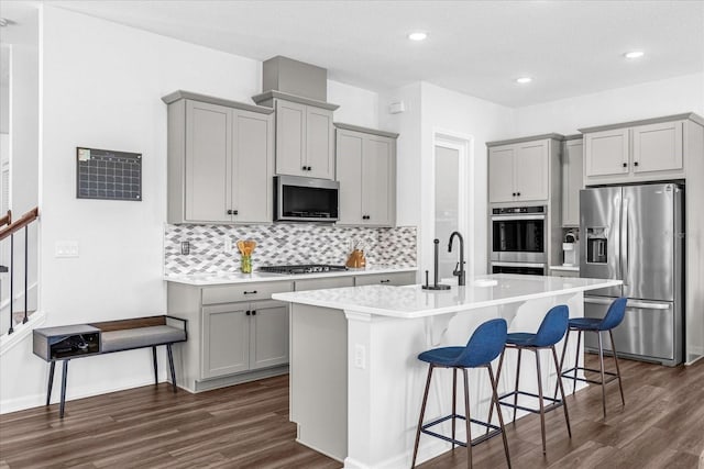 kitchen with appliances with stainless steel finishes, gray cabinets, and dark wood-type flooring