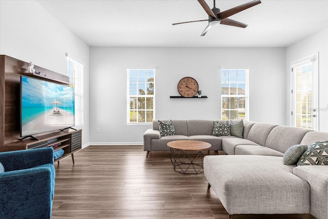 living room featuring dark hardwood / wood-style flooring, plenty of natural light, and ceiling fan