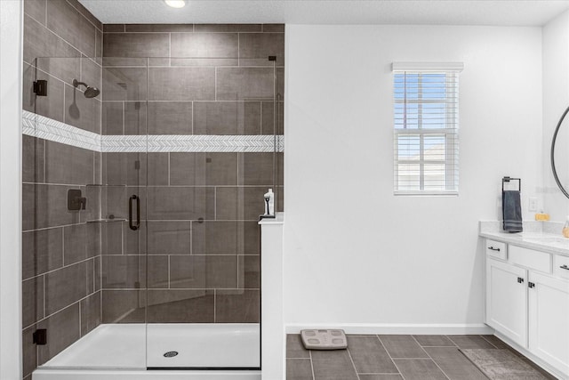 bathroom featuring tile patterned floors, vanity, and a shower with shower door