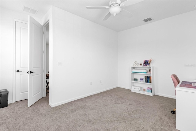 office featuring ceiling fan and light carpet