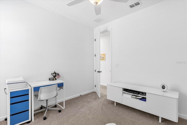 carpeted office featuring ceiling fan