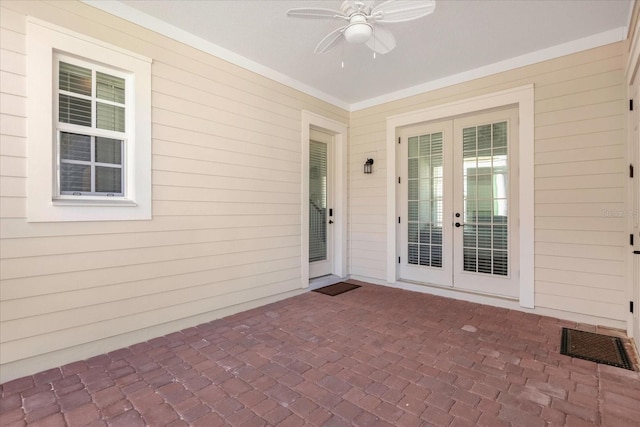 entrance to property featuring a patio area, ceiling fan, and french doors