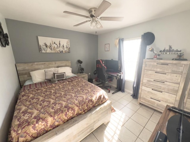 bedroom featuring light tile patterned floors, baseboards, and a ceiling fan