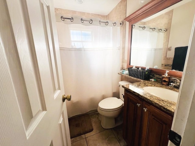 bathroom with tile patterned floors, vanity, and toilet