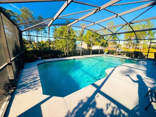 view of pool with a lanai and a patio