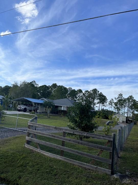 exterior space featuring fence and a lawn