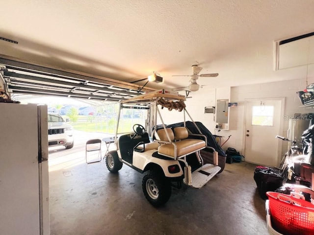 garage with electric panel, a garage door opener, and freestanding refrigerator