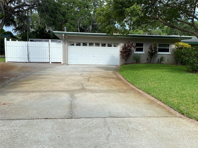 ranch-style home with a front yard and a garage