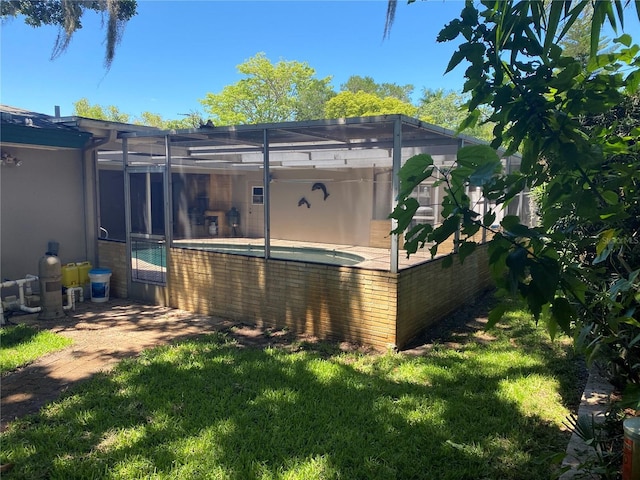 3240 San Mateo St, Clearwater, FL 33759 - rear view of house with a jacuzzi, a lanai, and a yard