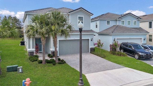 view of front of house featuring a garage and a front lawn