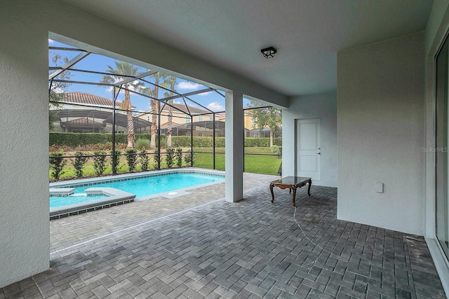 view of pool featuring a lanai, an in ground hot tub, and a patio area