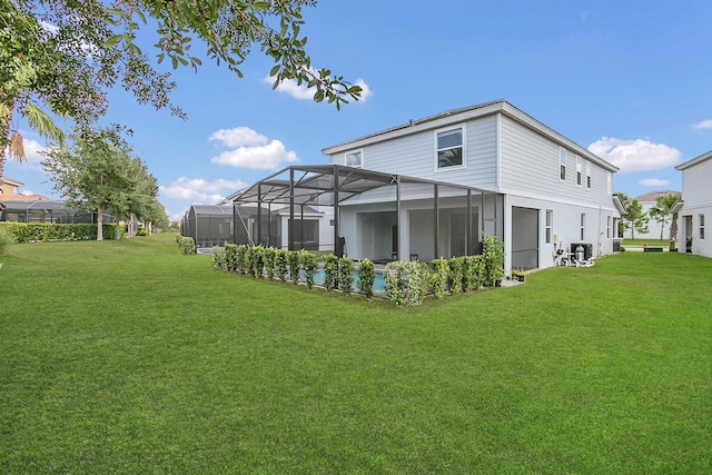 back of property featuring glass enclosure and a yard