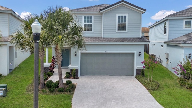 view of front of property featuring a garage and a front yard