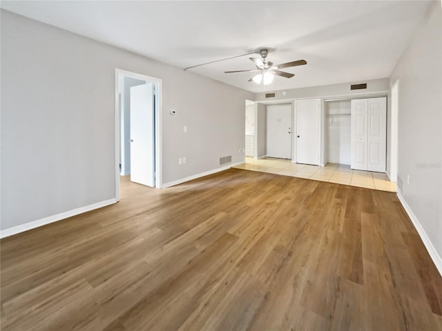 unfurnished bedroom with light hardwood / wood-style flooring and ceiling fan