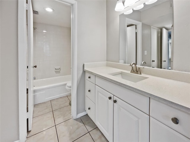 full bathroom with tile patterned flooring, vanity, toilet, and tiled shower / bath