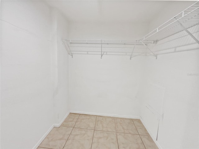 spacious closet featuring light tile patterned floors