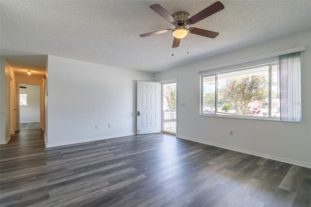 empty room featuring ceiling fan, dark hardwood / wood-style floors, and a textured ceiling