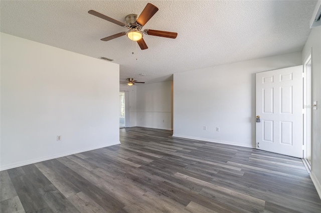 spare room with dark hardwood / wood-style floors, ceiling fan, and a textured ceiling