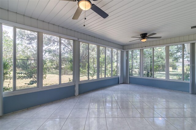 unfurnished sunroom with ceiling fan