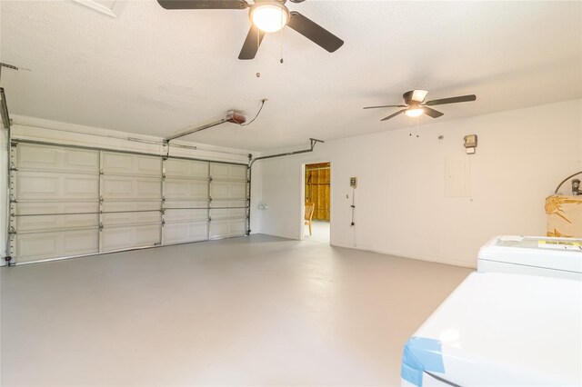 garage with ceiling fan, a garage door opener, and washer / dryer