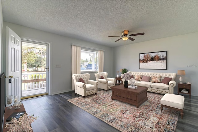 living room featuring a wealth of natural light, dark hardwood / wood-style flooring, ceiling fan, and a textured ceiling