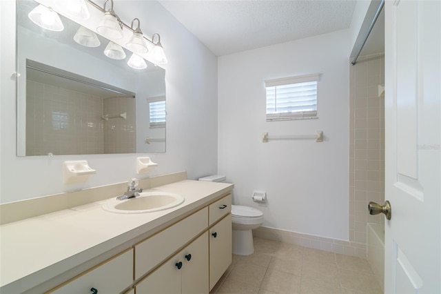 bathroom featuring a textured ceiling, washtub / shower combination, toilet, tile patterned floors, and vanity
