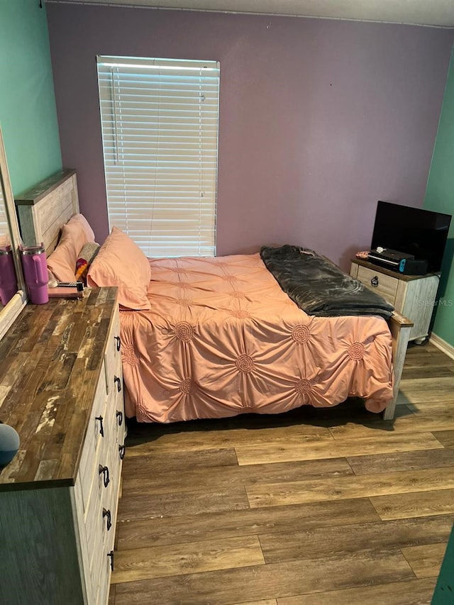 bedroom with dark wood-type flooring