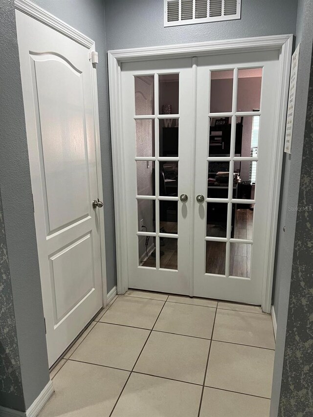 doorway to outside with french doors and light tile flooring