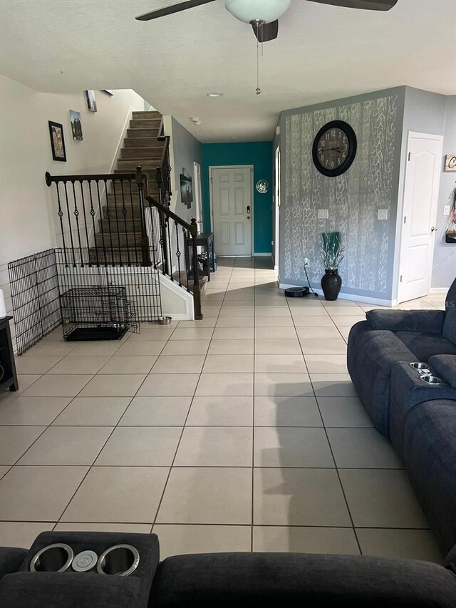 living room featuring ceiling fan and light tile floors