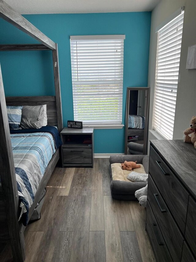 bedroom with dark wood-type flooring