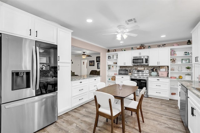 kitchen with tasteful backsplash, ceiling fan, light stone counters, and stainless steel appliances