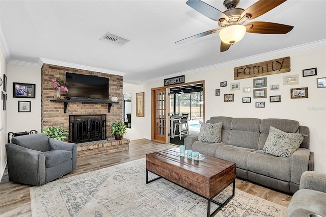 living room featuring crown molding, ceiling fan, and hardwood / wood-style floors