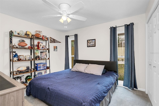 carpeted bedroom with a closet and ceiling fan