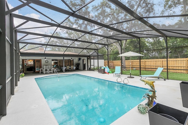 view of swimming pool with a patio and a lanai