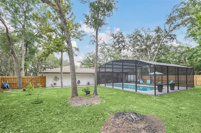 exterior space with a patio, glass enclosure, and a fenced in pool