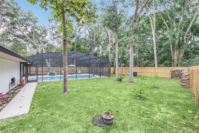 view of yard featuring glass enclosure and a fenced in pool