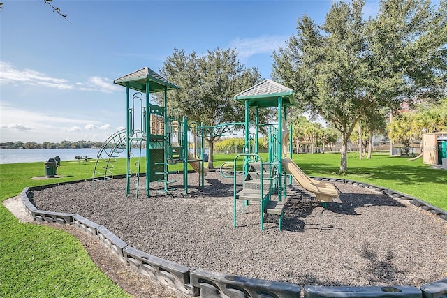 view of jungle gym featuring a water view and a yard