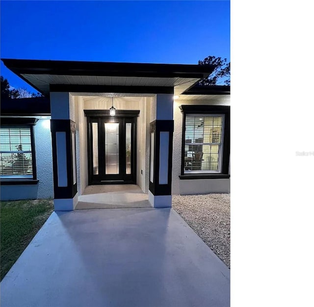 property entrance with stucco siding