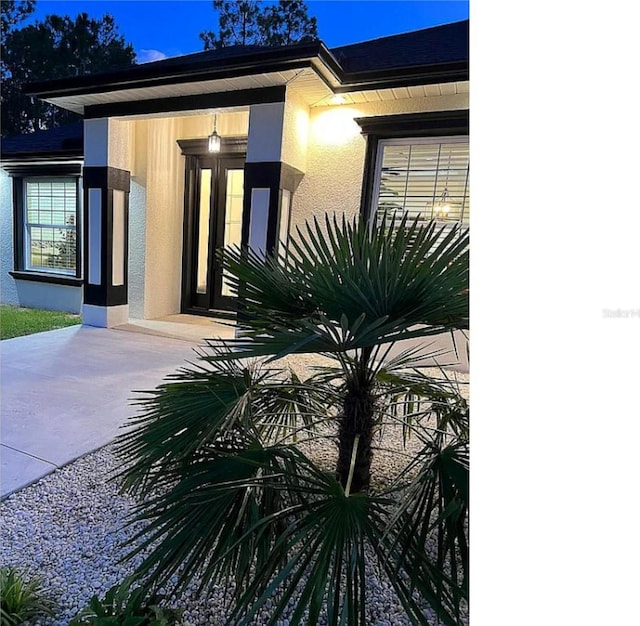 property entrance with stucco siding